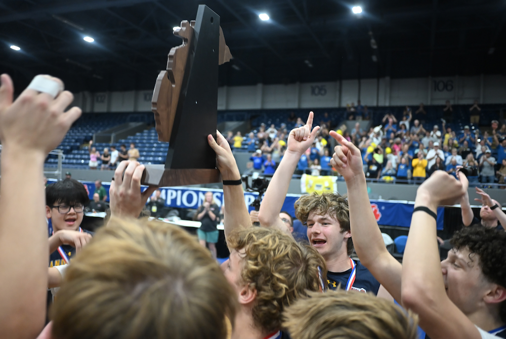 Grand Haven hoists its championship trophy Saturday afternoon at Kellogg Arena. 