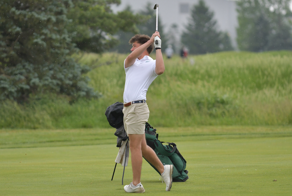 A Cranbrook Kingswood golfer follows his approach shot. 