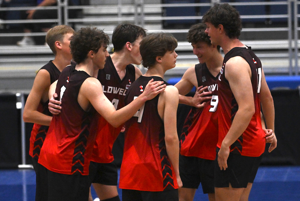 Lowell players huddle on the court during their Division 2 championship win Saturday at Kellogg Arena.