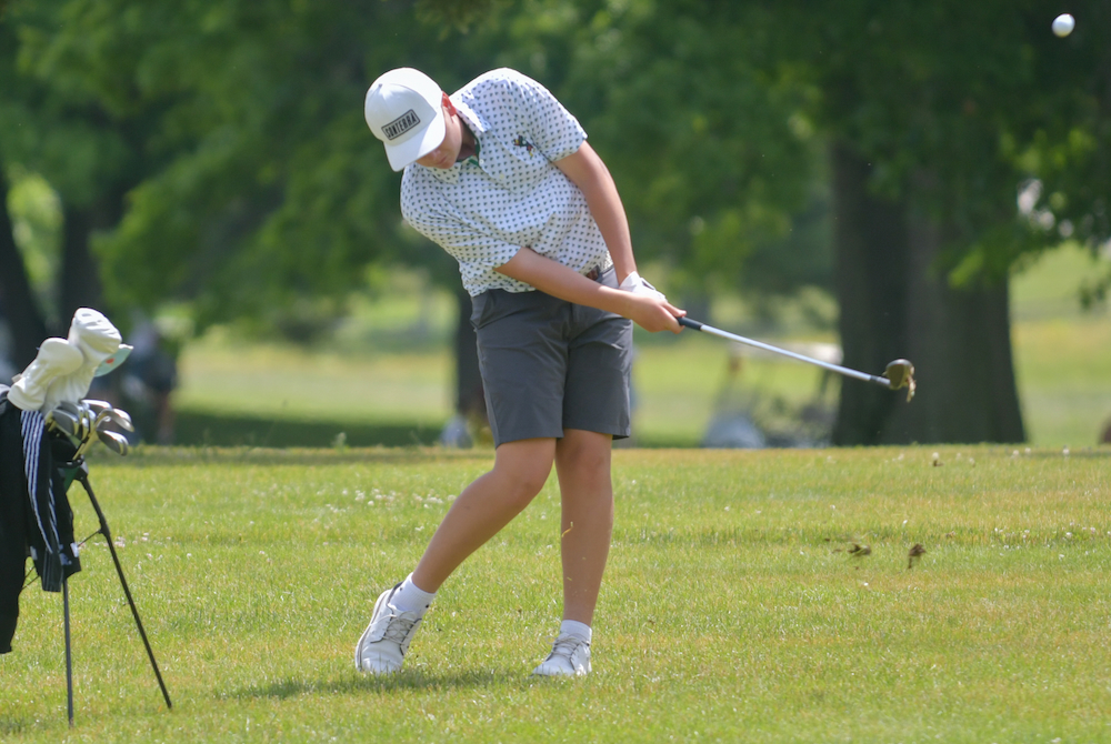 A Grand Rapids West Catholic golfer hits a wedge shot. 