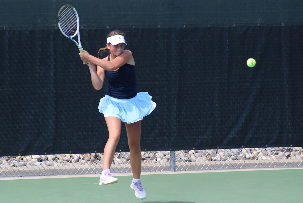 Country Day's Chloe Conniff sends a backhand during her No. 1 singles championship match Saturday.