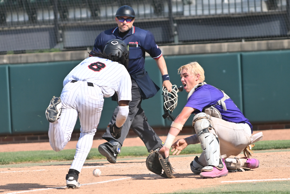 Kalamazoo Christian catcher Jace Rarick prepares to put a tag on Detroit Edison's DaiJon Brooks (8) during the Comets' Division 3 Semifinal win Thursday at McLane Stadium. 