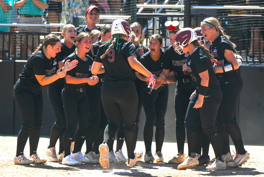 Walled Lake Northern welcomes Shaela Byrnes (9) as she crosses the plate after her go-ahead sixth-inning home run. 