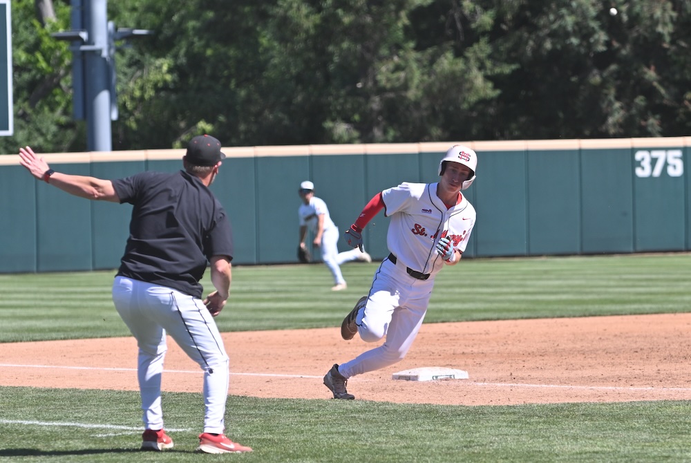 An Orchard Lake St. Mary's runner rounds third base Saturday as a Kenowa Hills throw comes in from the outfield. 