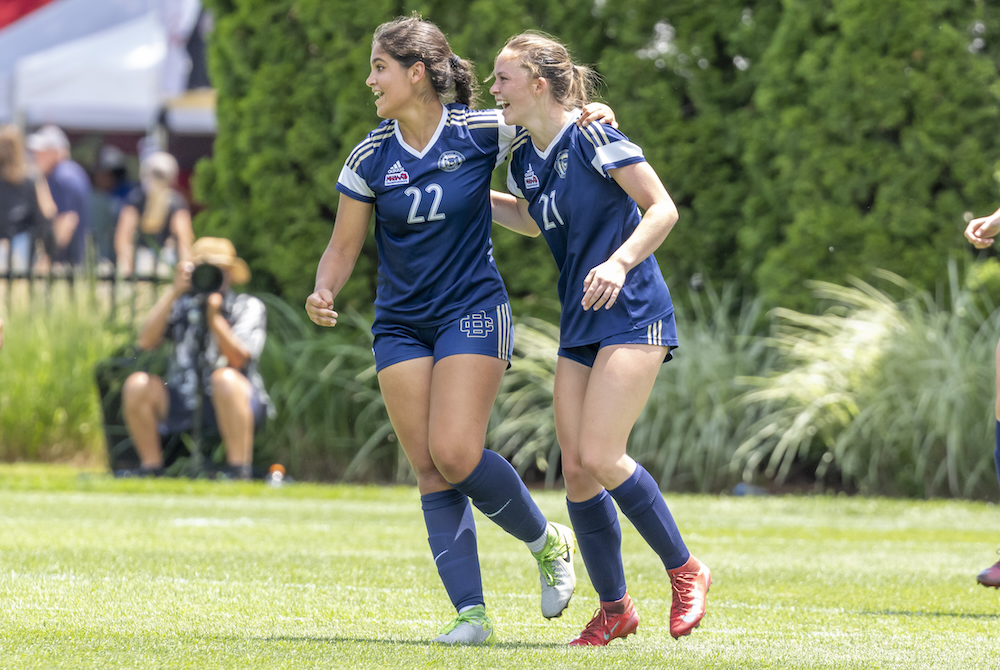 Detroit Country Day’s Megan Mateer (21) and Aliya Saad (22) enjoy a moment during their team’s Division 3 championship win Saturday at DeMartin Stadium. 