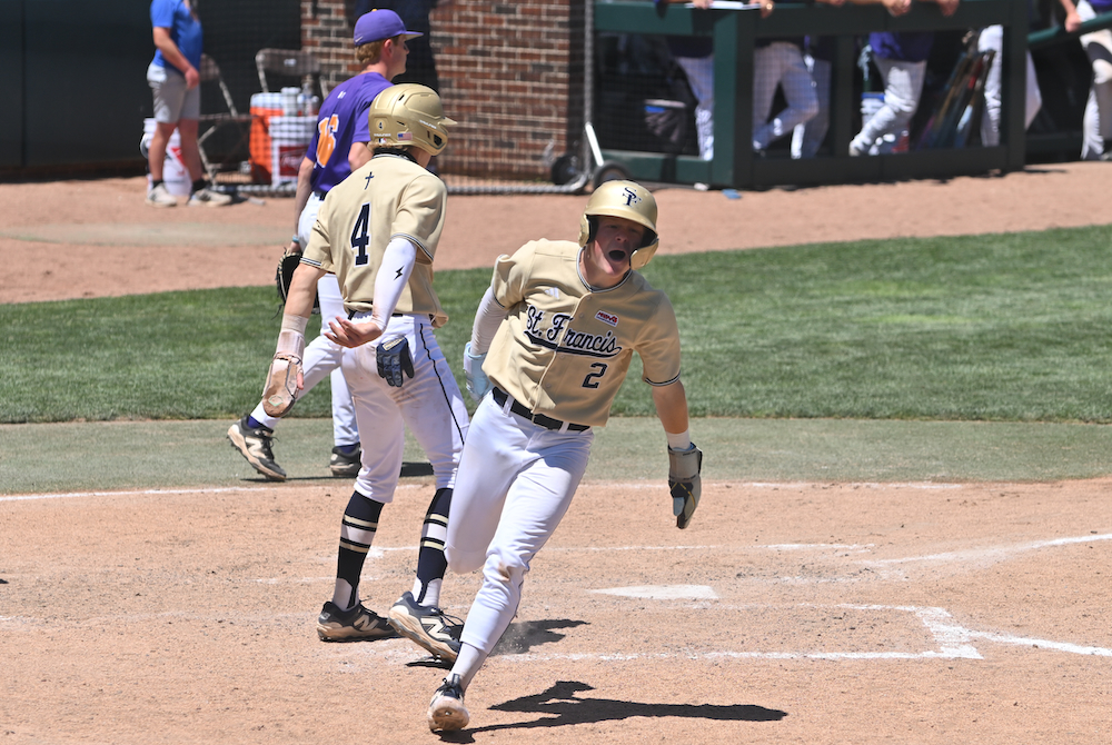 Traverse City St. Francis' Tyler Thompson (2) runs back to his dugout after crossing the plate during the Division 3 Final on Saturday. 