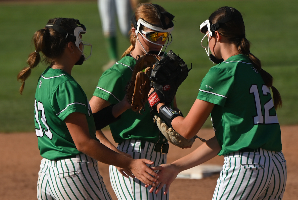 Mendon’s Rowan Allen (33), Brynley Jungers (12) and Brooke Gerth (6) get ready to start an inning Saturday at Secchia Stadium. 