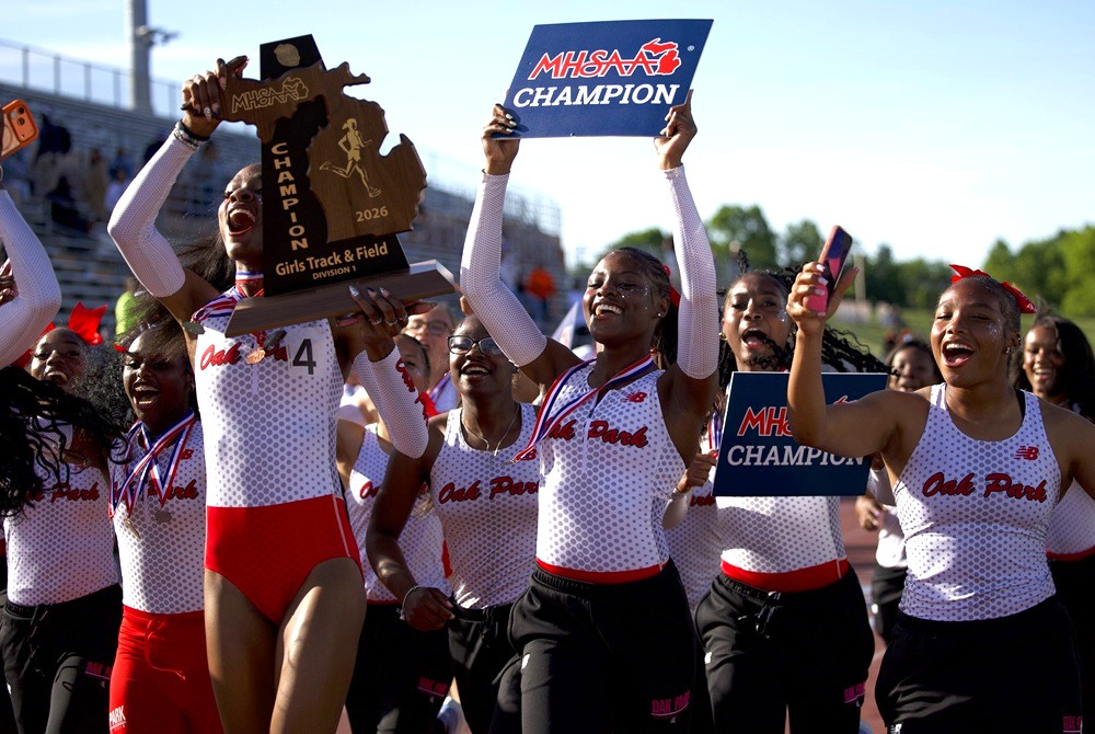 The Oak Park girls track & field team hoist their championship trophy and sign May 30 at Rockford High School.