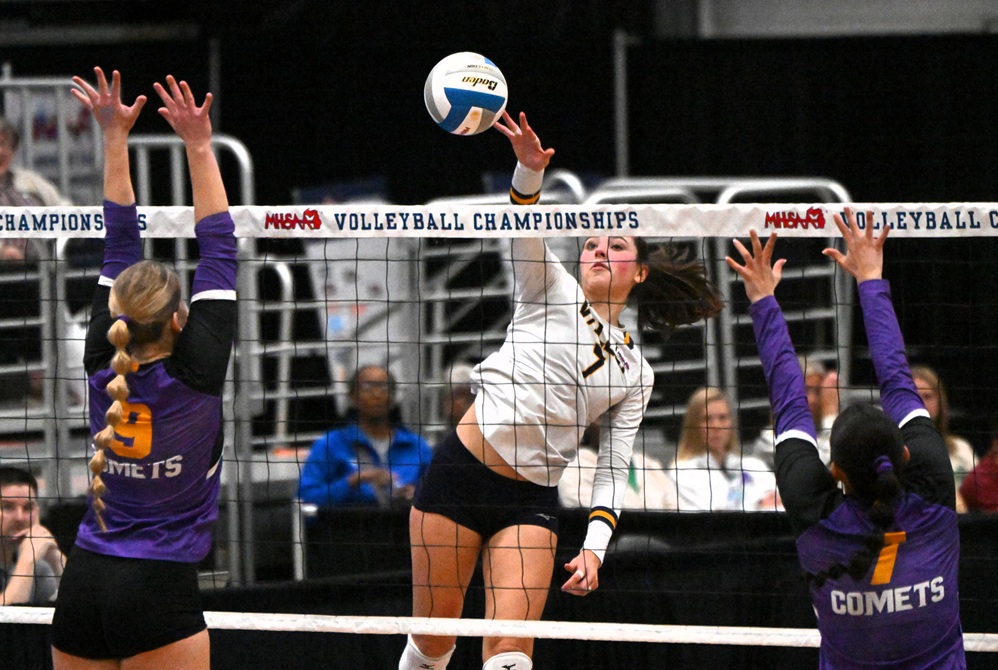 Saginaw Valley Lutheran’s Grace Parker (7) sends a kill attempt into the Kalamazoo Christian front line during last season’s Division 3 Semifinals.