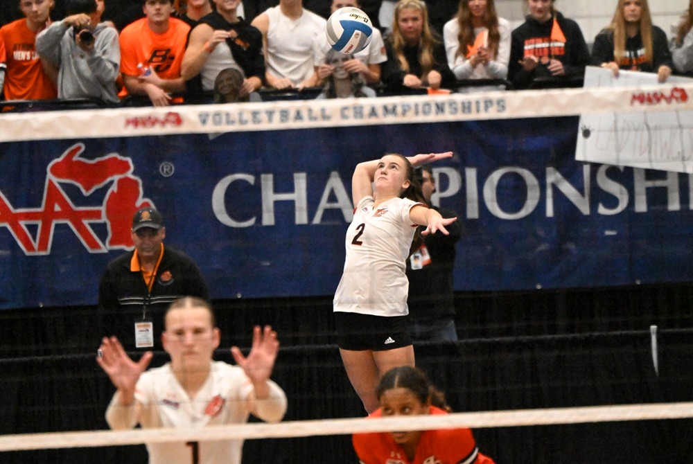 Mallory Johnson (2) serves during last season’s Division 1 Semifinal against Farmington Hills Mercy. 