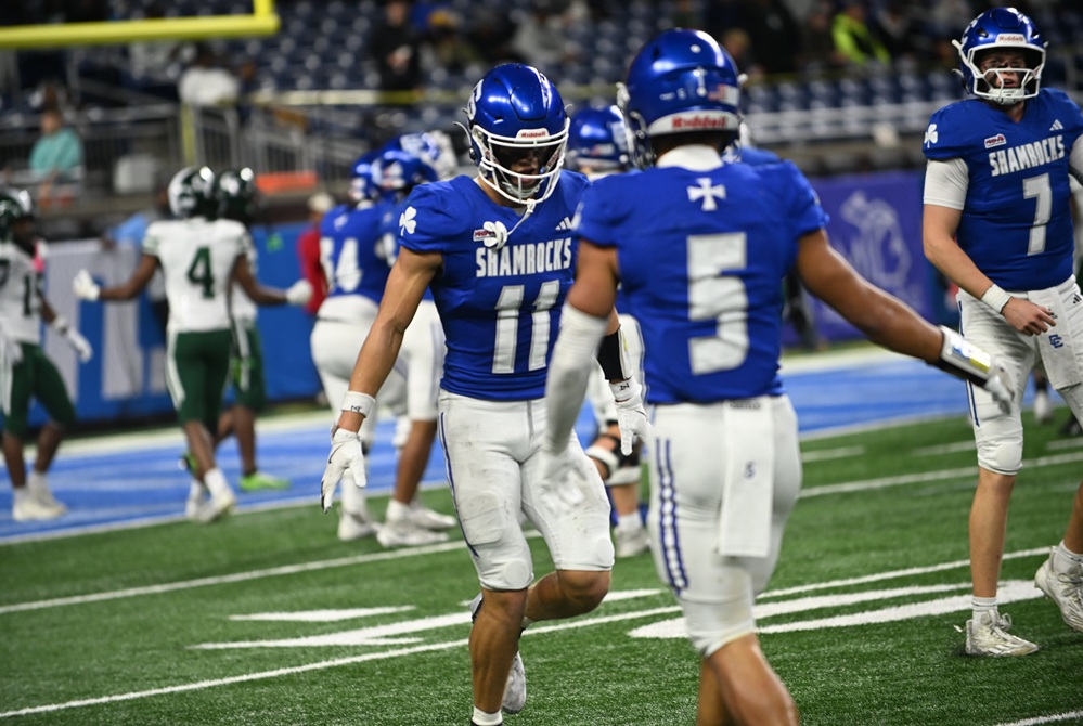 Detroit Catholic Central’s Gideon Gash (11) is congratulated by brother Samson Gash after scoring during last season’s Division 1 Final. 