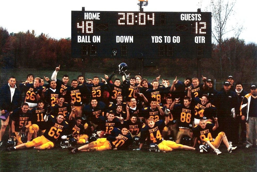 DeWitt freshman coach Wayne Shooks, fourth from right, stands for a photo with this final football team in 2004.