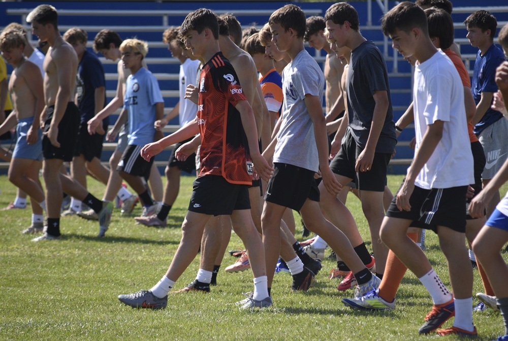 Edwardsburg soccer players warm up during a yoga and calisthenics session.