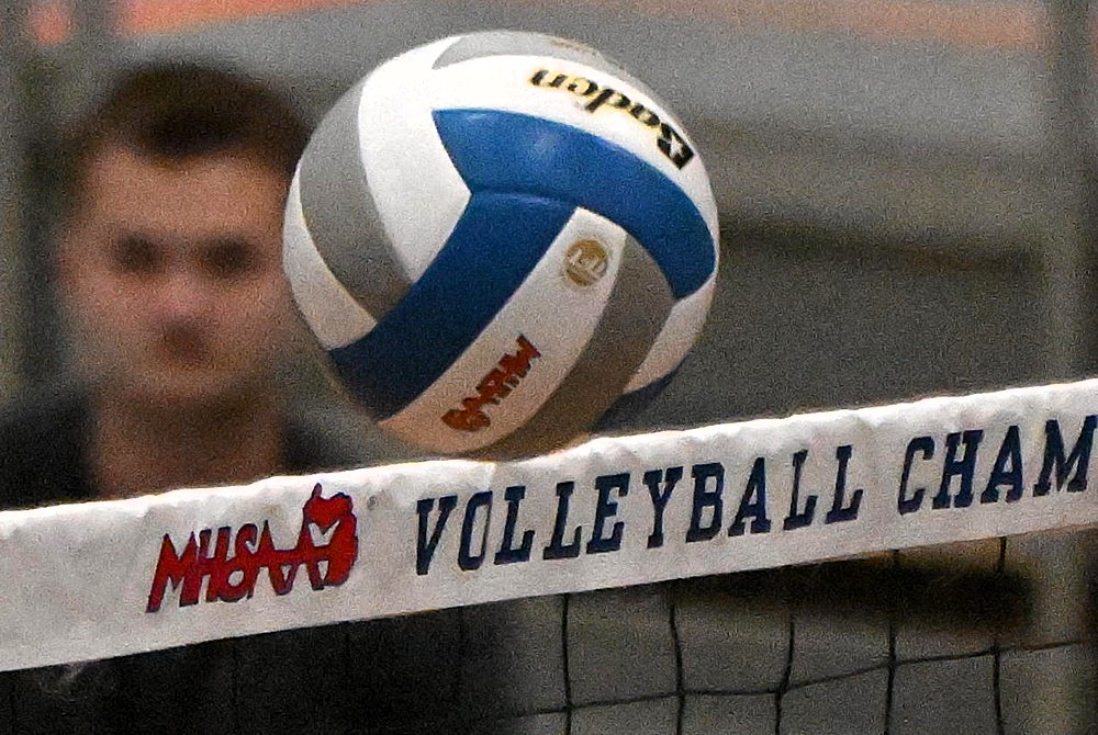 This is a photo of a volleyball brushing up against the top of the net during an MHSAA Finals match.