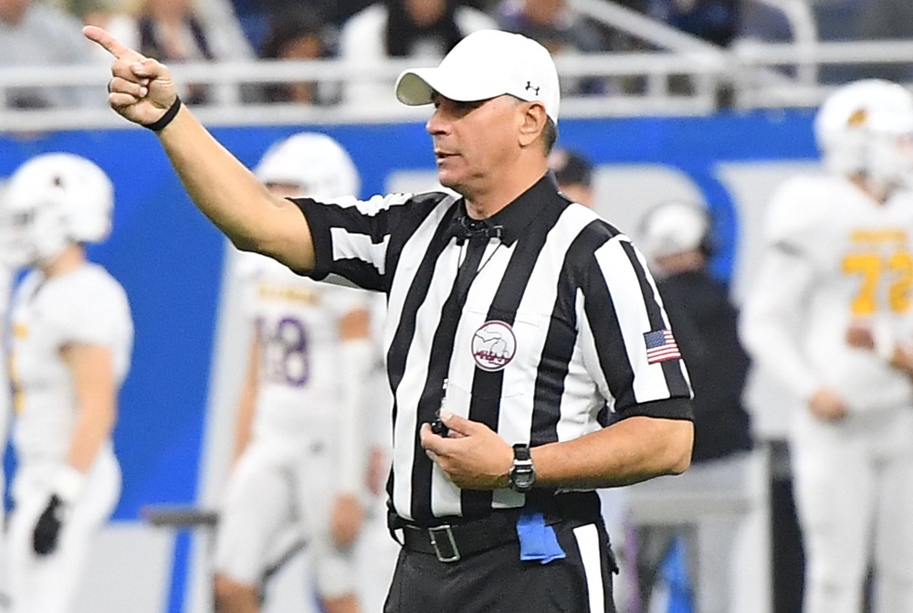 This football official is signaling a first down. 