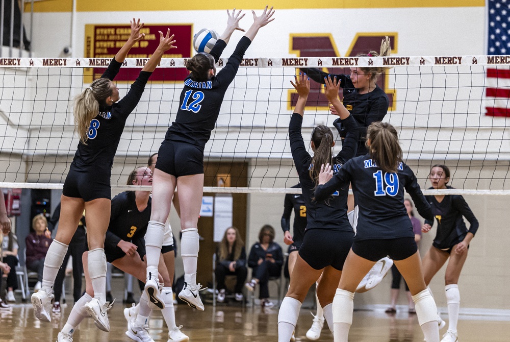 Bloomfield Hills Marian puts up a block during its match against Farmington Hills Mercy last week.