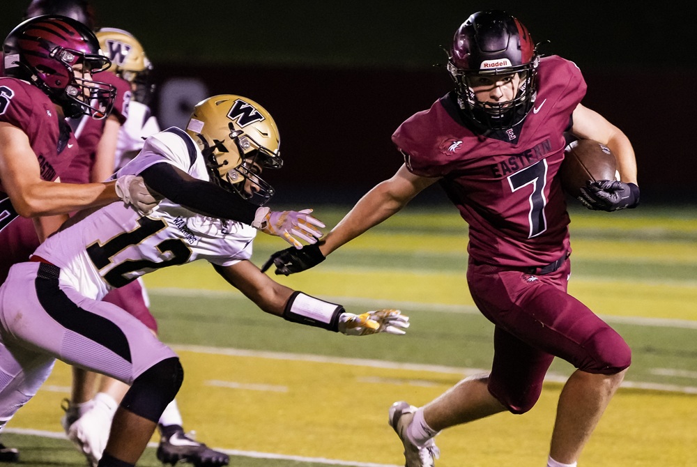 An Ada Forest Hills Eastern ball carrier attempts to hold off a Flint Elite defender during FHE’s Week 3 win. 