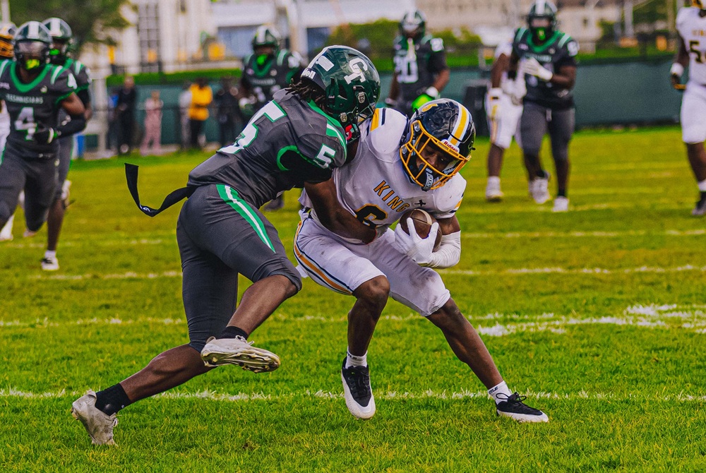 Detroit Cass Tech’s Marquell Evans Jr. (5) wraps up Detroit King’s De’Andre Williams.