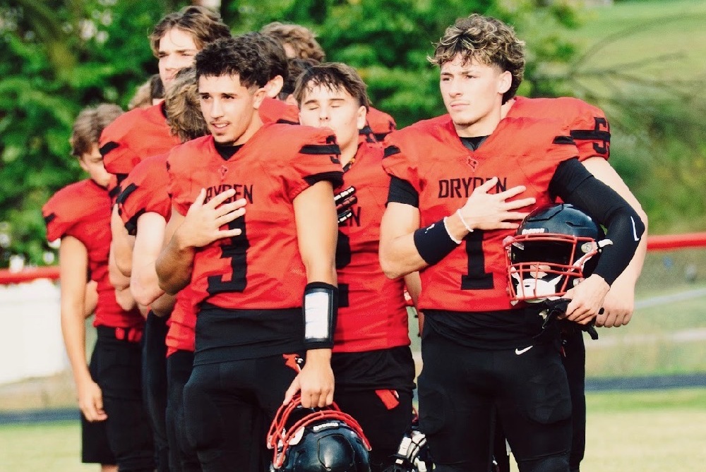 From left, Gianni Coscione and Santiago Perales stand with their team for the national anthem. 
