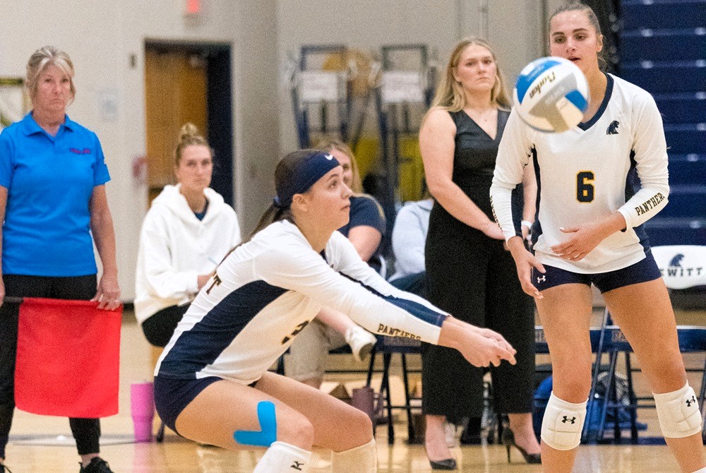 DeWitt returns a volley during a match this season against Okemos. 