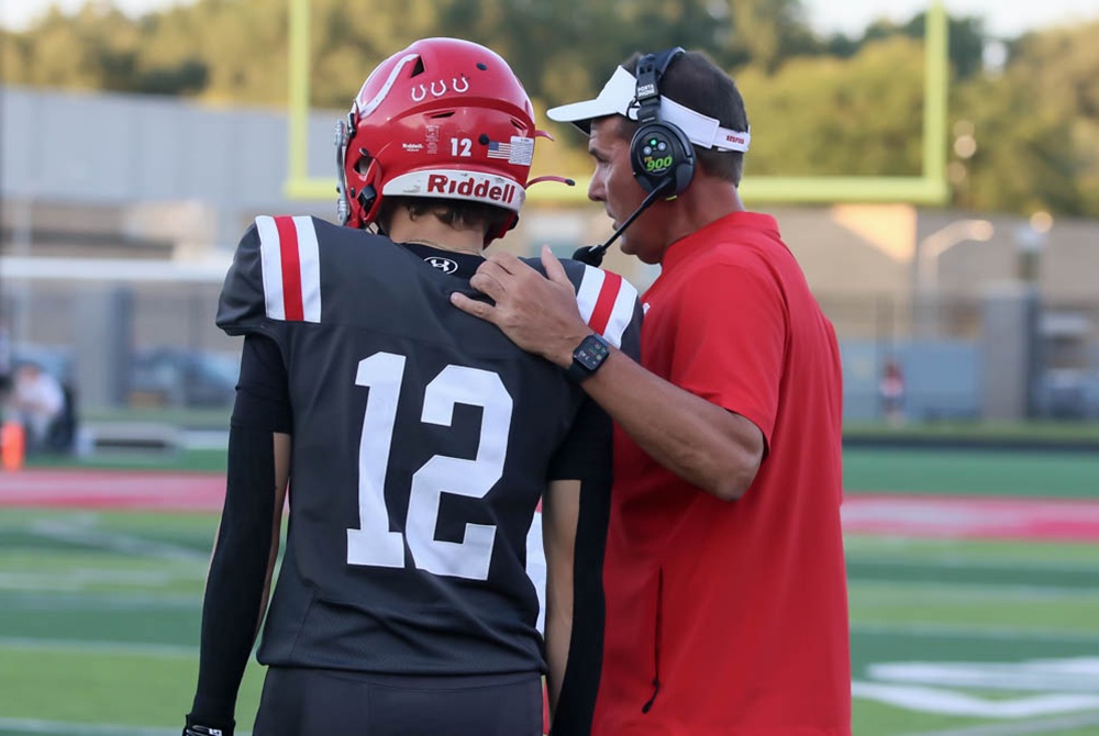 Temperance Bedford football coach Dave Misfud instructs player Brady Boisselle during a game this season.
