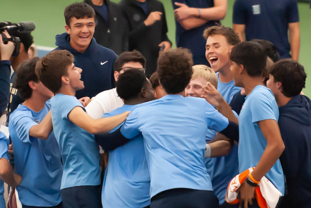 Detroit Country Day’s tennis team celebrates clinching the Division 3 championship Saturday at Midland Tennis Center. 