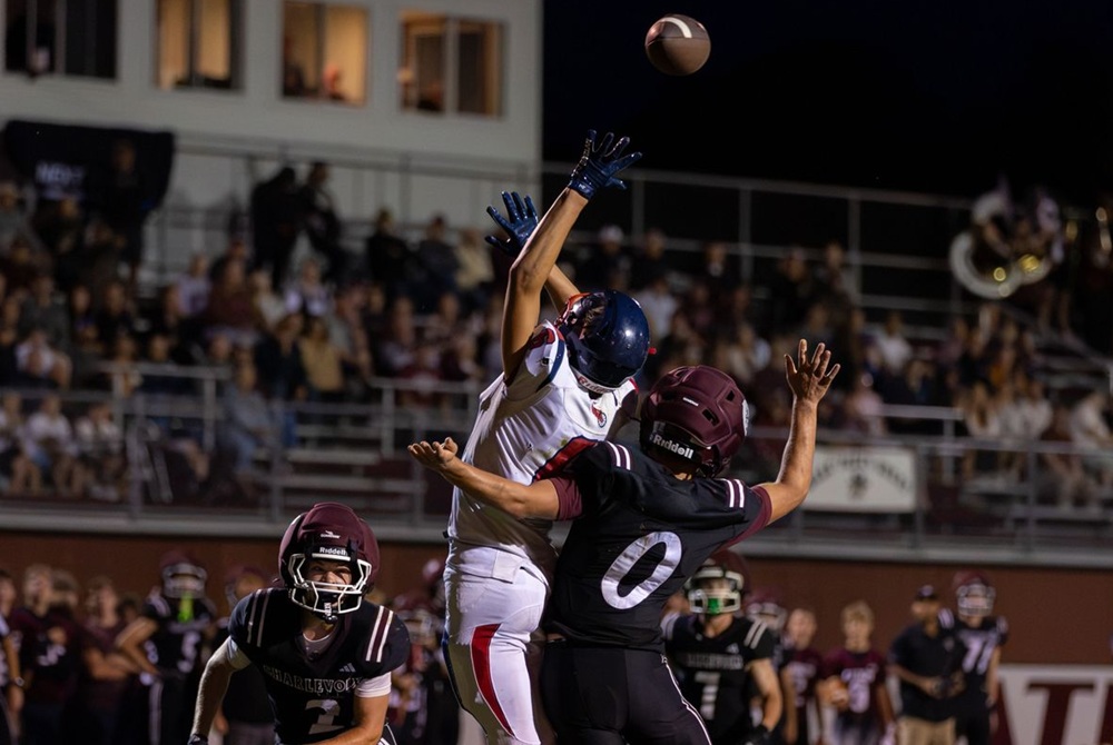 A Boyne City receiver attempts to get his hands on a pass over Charlevoix defenders during the Rayders’ 28-12 Week 2 victory.