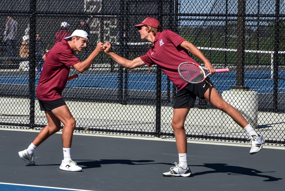 Holland Christian’s Michael Gorno and Graham Tanis bump fists in celebration during a match this fall.