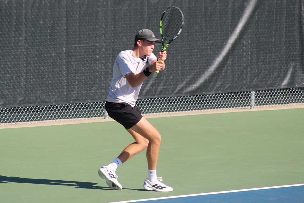 South Lyon East's Mason Crosby sends a backhand during his No. 1 singles championship match.