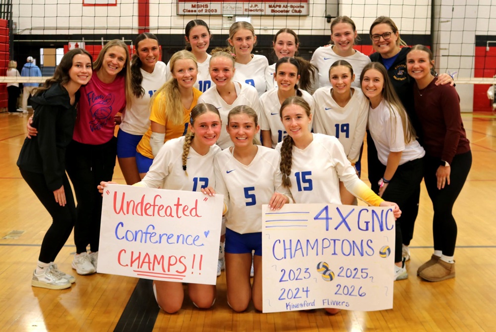 Kingsford players and coaches pose for a photo together after clinching a fourth-straight league championship.