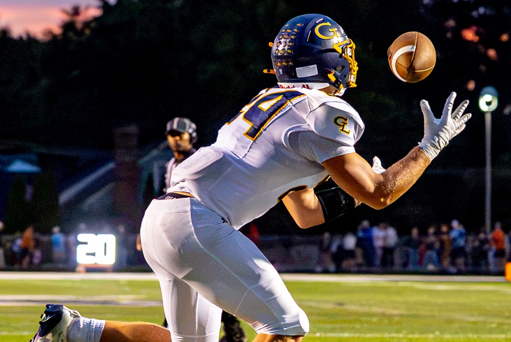 A Grand Ledge receiver focuses on hauling in a pass during the Comets’ 49-25 Week 4 win over East Lansing. 
