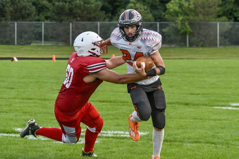 A Morrice ball carrier pulls away during a 68-14 win over Vestaburg.