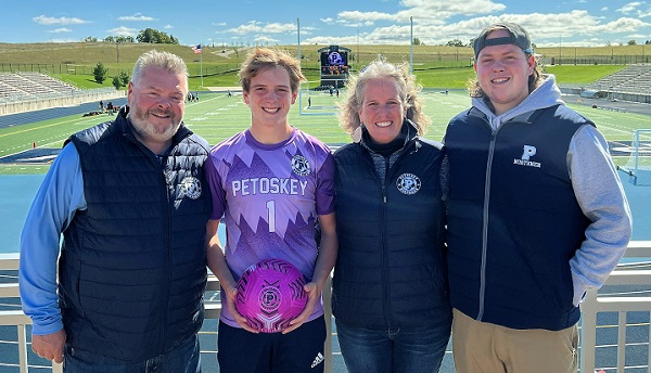 Mainland, second from left, shows Petoskey’s purple jersey, with his family (from left) Ken, Megan and Corbin Mainland. 