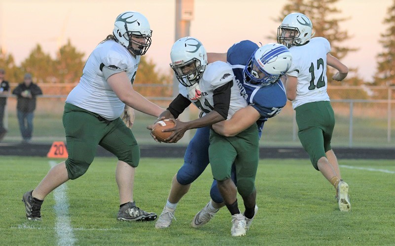 A Beal City defender wraps up a Pine River ball carrier during the Aggies’ 49-6 victory.