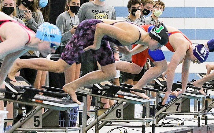 Grace Albrecht, middle, begins her launch from the starting blocks during last season’s LPD2 50 freestyle final. 