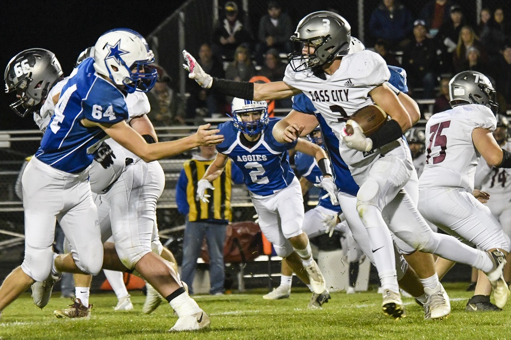 A Cass City ball carrier prepares to take on a Beal City defender. 