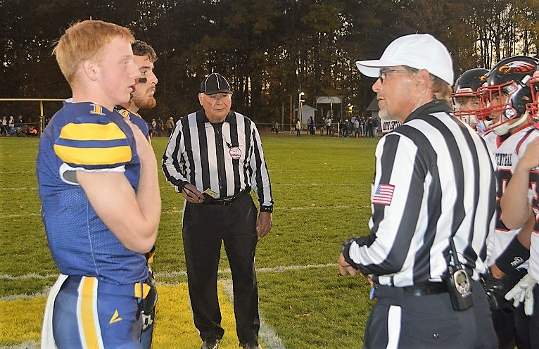 Crampton and Dauterman bring Whiteford and Pioneer North Central players together at midfield prior to Friday’s game. 