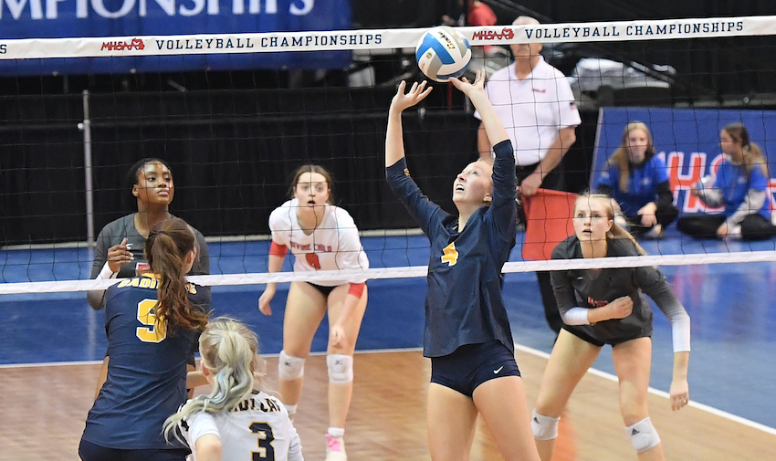 The Vikings’ Cassie Jenema (4) sets for her teammates as Divine Child awaits on the other side of the net. The Falcons finished this fall 16-19-1.