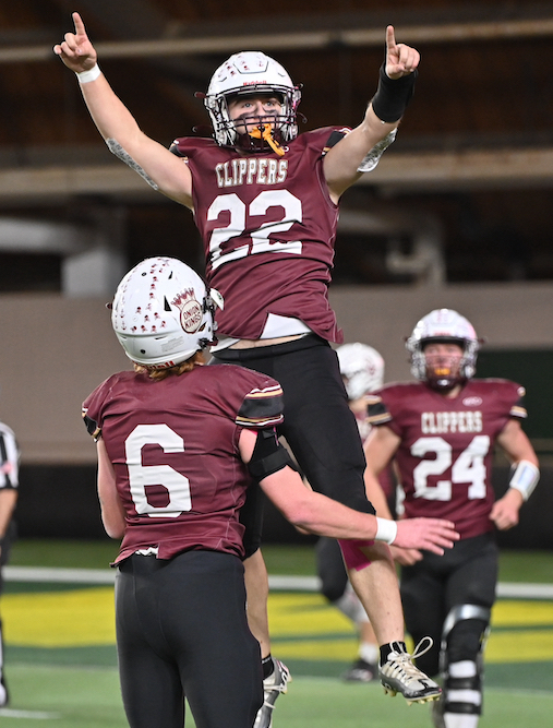 The Clippers’ Karter Ribble (22) gets some air while celebrating at the Superior Dome. 