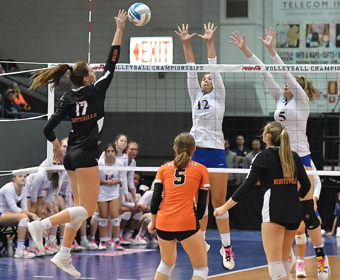 Northville’s Abby Reck (17) sends a kill attempt at Swanson and Ella Schomer (12).