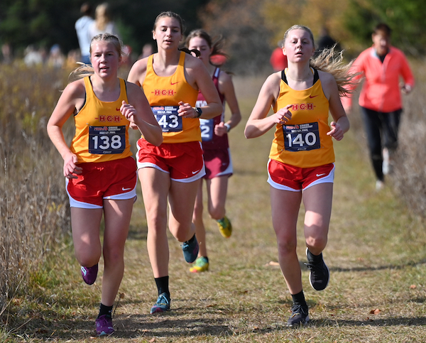 Hancock's Ella Keranen (138), Rayna Towles (143), and Maylie Kilpela (140) run together during the Division 2 Final.