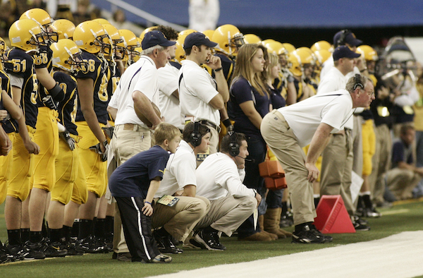 EGR coach Peter Stuursma, kneeling center, monitors the action during the 2010 championship game. 