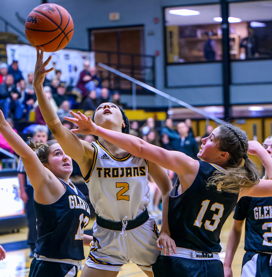 Traverse City Central’s Jakiah Brumfield (2) splits two defenders on her way to scoring in the Trojans' 41-29 win over previously-undefeated Glen Lake last week. 