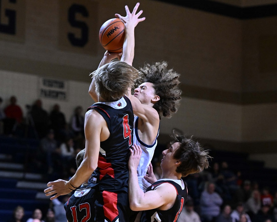 Marshall defenders wall off an Otsego player driving to the basket during a 52-43 win Jan. 6. 