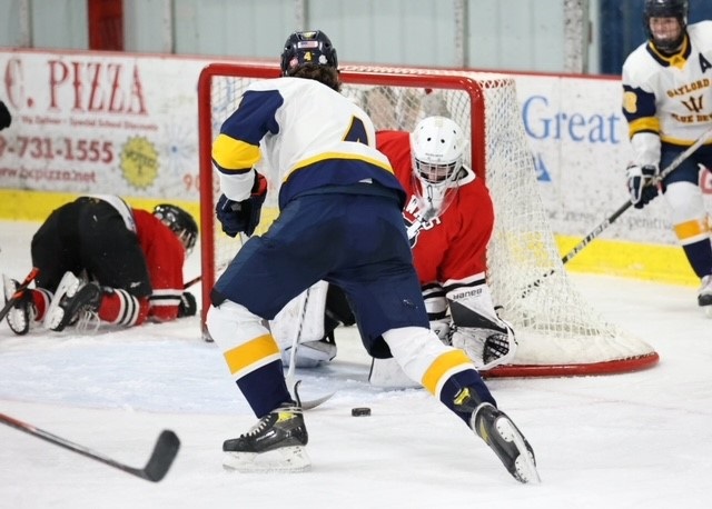 Looker tries to stuff the puck past Tawas’ goaltender.