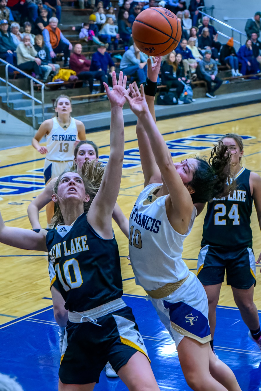 Maddie Bradford of Maple City Glen Lake contests a shot by Maggie Napont of Traverse City St. Francis during the Lakers' 51-45 win over the Gladiators last week. 