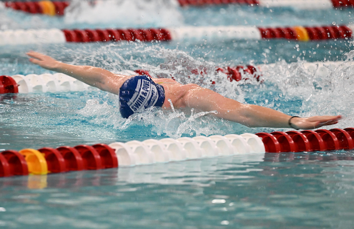 An Ishpeming/Negaunee athlete races in the butterfly.