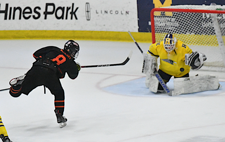 Evan Wohlart (8), who later scored the game winner in Brighton’s 4-3 triple-overtime win in Division 1 on Friday, has a shot blocked by Hartland goalie Colin Babcock.