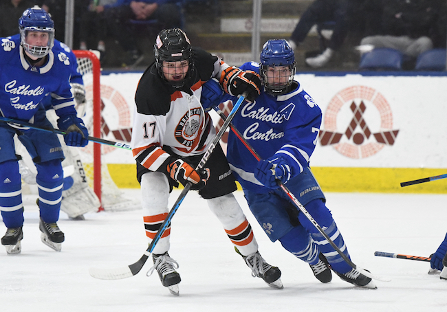 The Bulldogs' Nathan Daavettila (17) and the Shamrocks' Griffin Crampton pursue the puck.