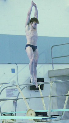 Grosse Pointe South’s Logan Hepner launches during his repeat pursuit in diving.